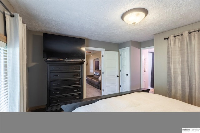 605 2nd St, Waterloo, NE 68069 - bedroom featuring a textured ceiling and ensuite bathroom