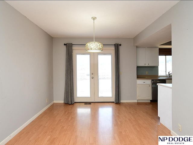 12067 Patrick Ave, Omaha, NE 68164 - kitchen with light wood-type flooring, dishwasher, french doors, and baseboards