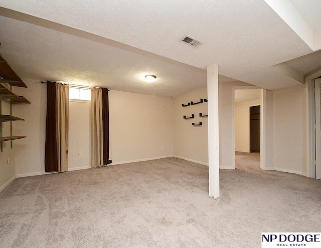 12067 Patrick Ave, Omaha, NE 68164 - basement with carpet flooring, baseboards, and a textured ceiling