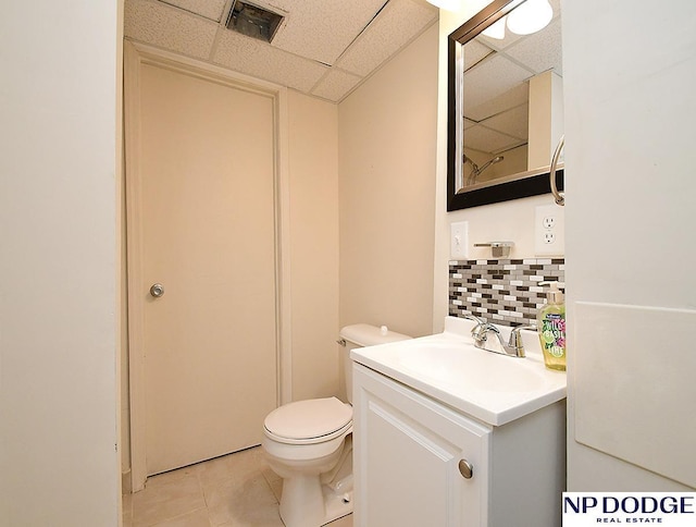 12067 Patrick Ave, Omaha, NE 68164 - full bathroom with a drop ceiling, tasteful backsplash, vanity, toilet, and tile patterned floors