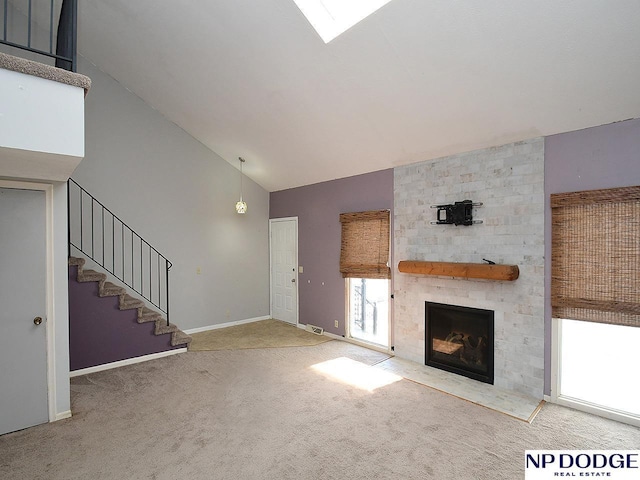 12067 Patrick Ave, Omaha, NE 68164 - unfurnished living room featuring carpet, a large fireplace, baseboards, stairway, and high vaulted ceiling