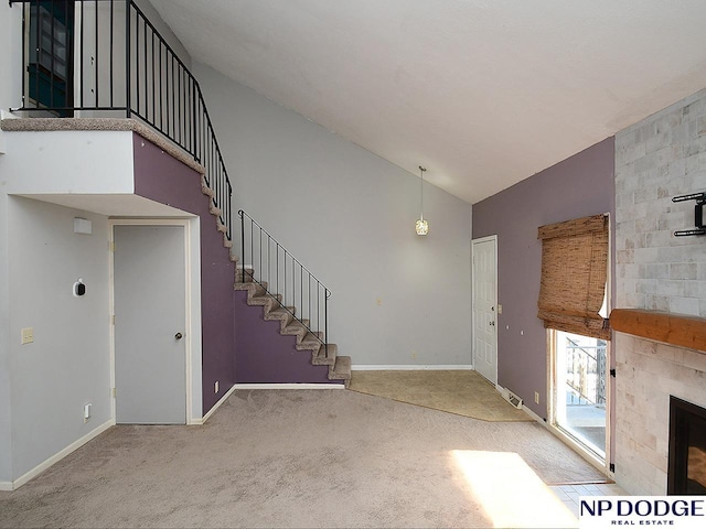 12067 Patrick Ave, Omaha, NE 68164 - unfurnished living room with carpet floors, high vaulted ceiling, stairway, baseboards, and a large fireplace