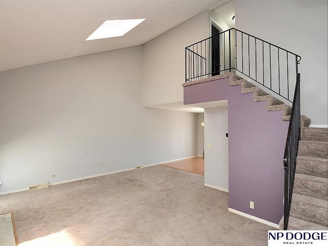 12067 Patrick Ave, Omaha, NE 68164 - staircase with carpet floors, baseboards, and a skylight