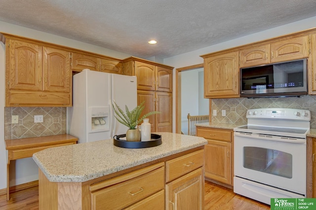 17139 S St, Omaha, NE 68135 - kitchen featuring white appliances, light wood-style floors, tasteful backsplash, recessed lighting, and a textured ceiling