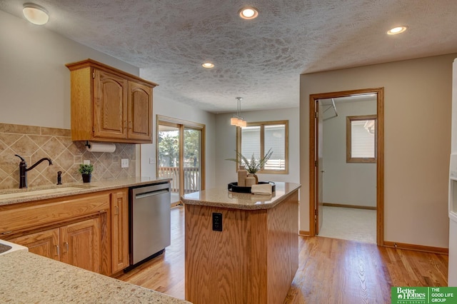 17139 S St, Omaha, NE 68135 - kitchen featuring stainless steel dishwasher, a center island, decorative backsplash, light wood-style flooring, and a sink