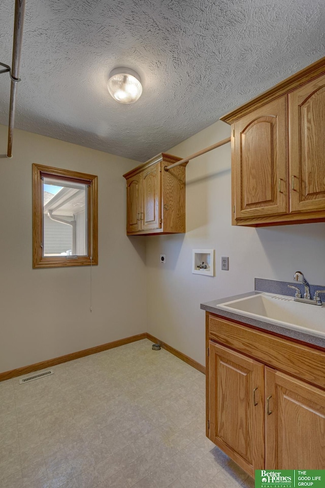 17139 S St, Omaha, NE 68135 - washroom featuring electric dryer hookup, hookup for a washing machine, light flooring, cabinet space, and baseboards