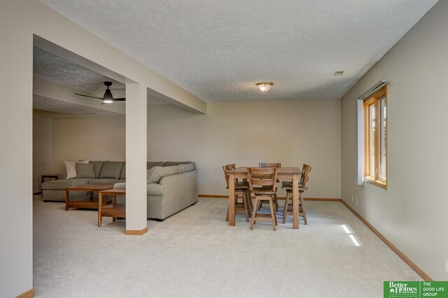 17139 S St, Omaha, NE 68135 - dining area with carpet flooring, baseboards, ceiling fan, and a textured ceiling