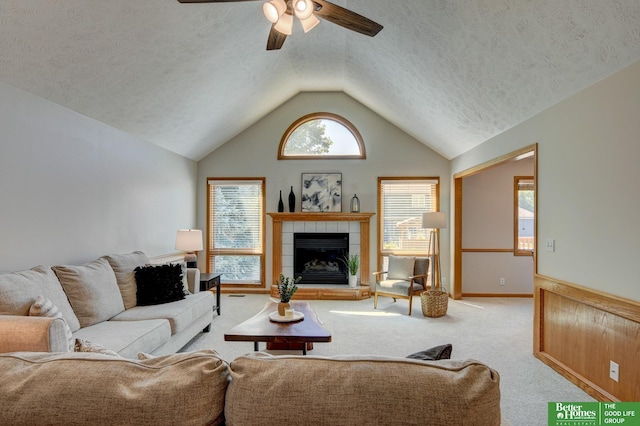 17139 S St, Omaha, NE 68135 - carpeted living area with a ceiling fan, vaulted ceiling, a fireplace, and a textured ceiling