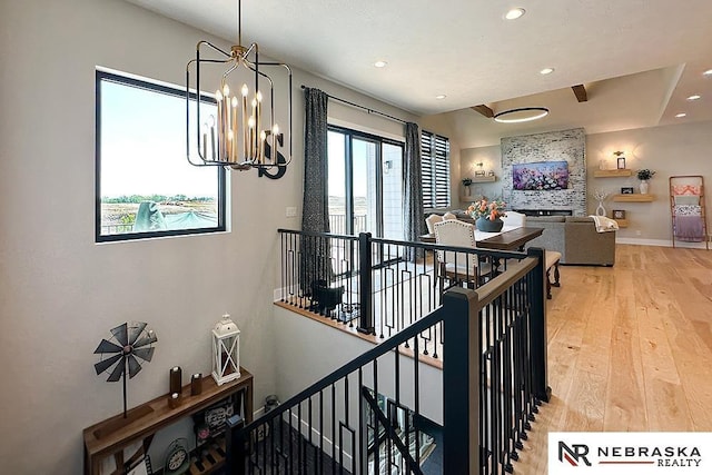 11473 S 189th St, Gretna, NE 68028 - staircase featuring wood finished floors, a chandelier, recessed lighting, and baseboards