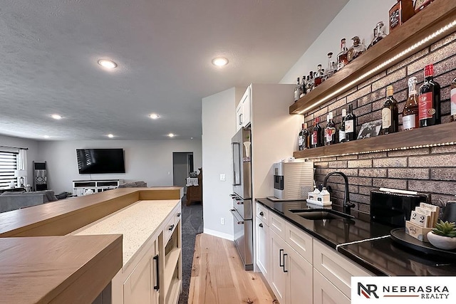 11473 S 189th St, Gretna, NE 68028 - kitchen with a sink, light wood-style flooring, recessed lighting, white cabinets, and open floor plan