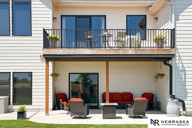 11473 S 189th St, Gretna, NE 68028 - back of property featuring a balcony, outdoor lounge area, and a patio