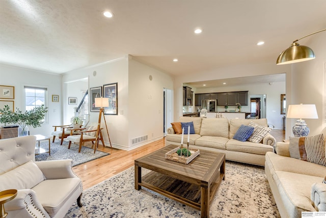 3814 S 186th Ave, Omaha, NE 68130 - living room featuring light wood-style floors, baseboards, recessed lighting, and ornamental molding
