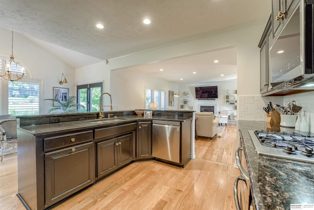 3814 S 186th Ave, Omaha, NE 68130 - kitchen with stainless steel appliances, a sink, open floor plan, vaulted ceiling, and dark brown cabinetry