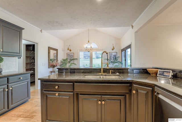 3814 S 186th Ave, Omaha, NE 68130 - kitchen featuring a sink, lofted ceiling, a chandelier, light wood finished floors, and pendant lighting