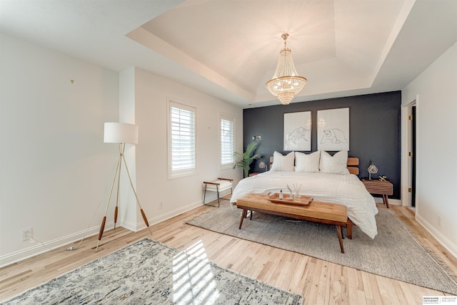 3814 S 186th Ave, Omaha, NE 68130 - bedroom with a raised ceiling, wood finished floors, a chandelier, and baseboards