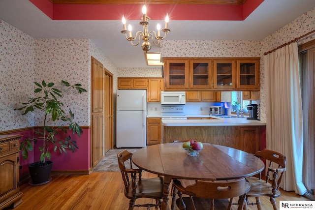9910 Ohio St, Omaha, NE 68134 - kitchen featuring white appliances, wallpapered walls, brown cabinetry, light wood finished floors, and light countertops