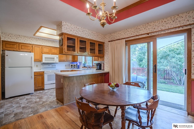 9910 Ohio St, Omaha, NE 68134 - dining space with wallpapered walls, a chandelier, and light wood-type flooring