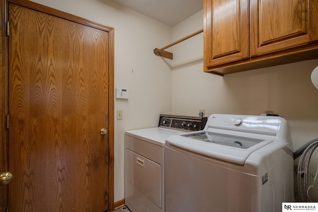 9910 Ohio St, Omaha, NE 68134 - laundry room featuring washer and dryer and cabinet space