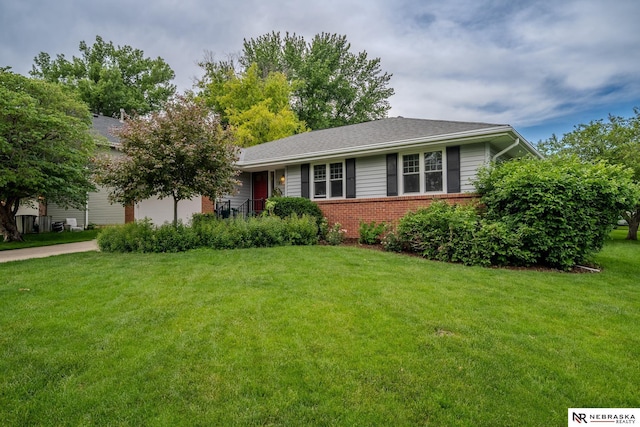 9910 Ohio St, Omaha, NE 68134 - view of front of property with a front lawn, brick siding, an attached garage, and driveway
