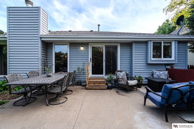 9910 Ohio St, Omaha, NE 68134 - back of house featuring entry steps, a chimney, a patio area, outdoor dining area, and a shingled roof