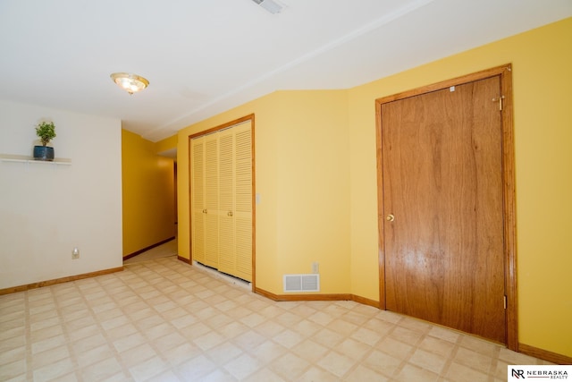 9910 Ohio St, Omaha, NE 68134 - unfurnished bedroom with light flooring, baseboards, and two closets