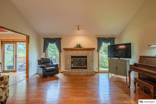 9910 Ohio St, Omaha, NE 68134 - living room featuring light wood-type flooring, a fireplace, and high vaulted ceiling