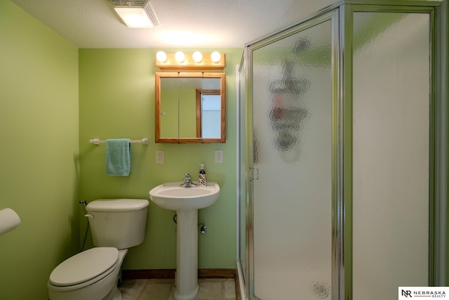 9910 Ohio St, Omaha, NE 68134 - bathroom featuring toilet, a shower stall, a sink, tile patterned floors, and baseboards