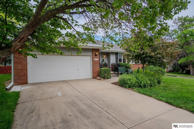 9910 Ohio St, Omaha, NE 68134 - view of front of property with brick siding, an attached garage, and concrete driveway