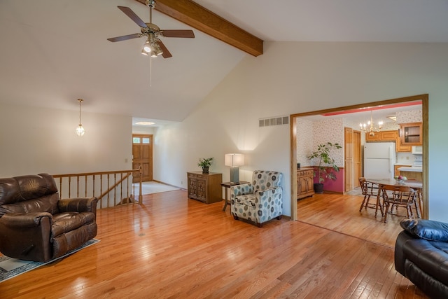 9910 Ohio St, Omaha, NE 68134 - living area with light wood finished floors, beamed ceiling, a ceiling fan, a chandelier, and high vaulted ceiling