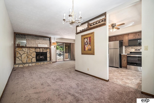 1214 Happy Hallow Ct, Plattsmouth, NE 68048 - unfurnished living room featuring light carpet, baseboards, a stone fireplace, and a chandelier