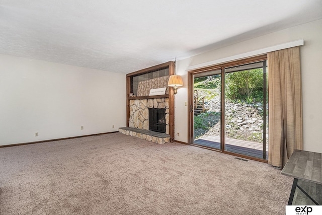 1214 Happy Hallow Ct, Plattsmouth, NE 68048 - unfurnished living room featuring carpet flooring, a stone fireplace, and baseboards