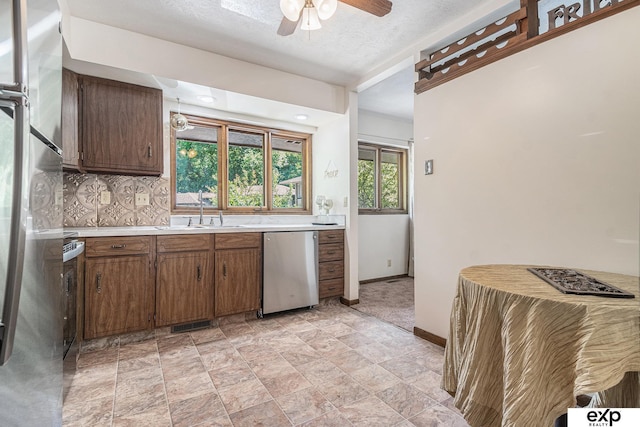 1214 Happy Hallow Ct, Plattsmouth, NE 68048 - kitchen with appliances with stainless steel finishes, a sink, light countertops, a ceiling fan, and baseboards