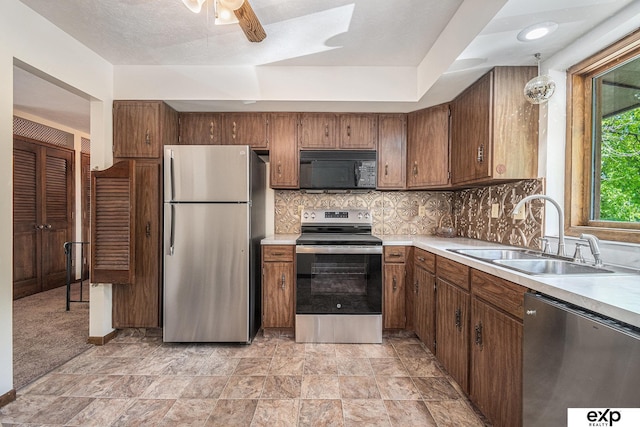 1214 Happy Hallow Ct, Plattsmouth, NE 68048 - kitchen featuring stainless steel appliances, a sink, light countertops, a ceiling fan, and decorative backsplash