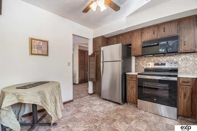 1214 Happy Hallow Ct, Plattsmouth, NE 68048 - kitchen with appliances with stainless steel finishes, light countertops, ceiling fan, tasteful backsplash, and brown cabinetry