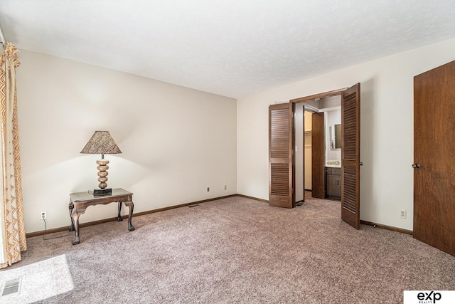 1214 Happy Hallow Ct, Plattsmouth, NE 68048 - unfurnished bedroom featuring carpet, baseboards, and connected bathroom