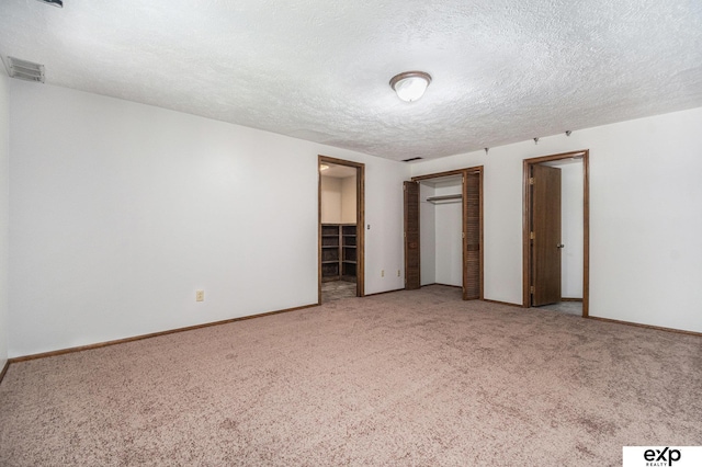 1214 Happy Hallow Ct, Plattsmouth, NE 68048 - unfurnished bedroom featuring carpet, a textured ceiling, baseboards, and a closet