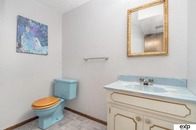 1214 Happy Hallow Ct, Plattsmouth, NE 68048 - bathroom featuring vanity, toilet, baseboards, and a textured ceiling