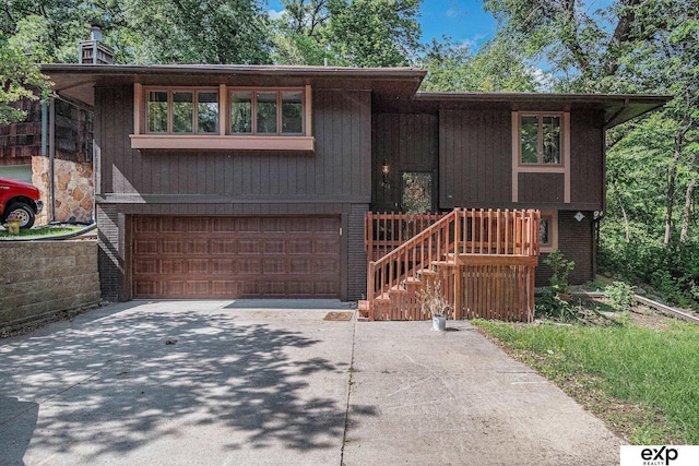 1214 Happy Hallow Ct, Plattsmouth, NE 68048 - view of front of home with concrete driveway, an attached garage, and a chimney