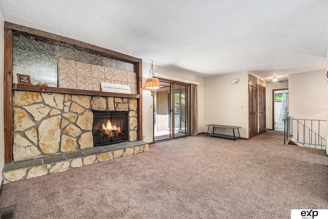 1214 Happy Hallow Ct, Plattsmouth, NE 68048 - unfurnished living room with carpet floors, a stone fireplace, plenty of natural light, and a textured ceiling