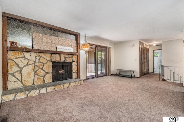 1214 Happy Hallow Ct, Plattsmouth, NE 68048 - unfurnished living room featuring carpet floors, a fireplace, and a textured ceiling
