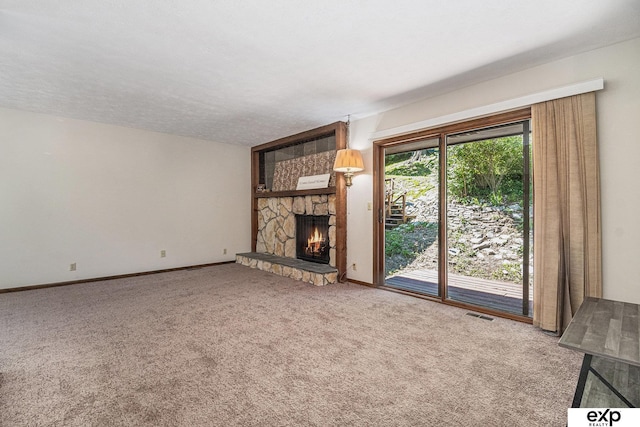 1214 Happy Hallow Ct, Plattsmouth, NE 68048 - unfurnished living room with carpet flooring, a stone fireplace, and baseboards