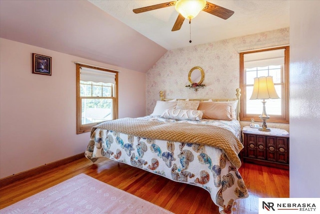 4542 Charles St, Omaha, NE 68132 - bedroom featuring lofted ceiling, wood finished floors, wallpapered walls, baseboards, and ceiling fan