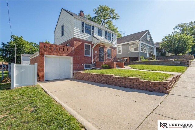 4542 Charles St, Omaha, NE 68132 - view of front facade with brick siding, concrete driveway, a garage, and a chimney