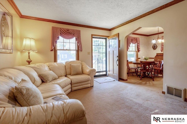 4542 Charles St, Omaha, NE 68132 - living area with arched walkways, carpet floors, a chandelier, crown molding, and a textured ceiling