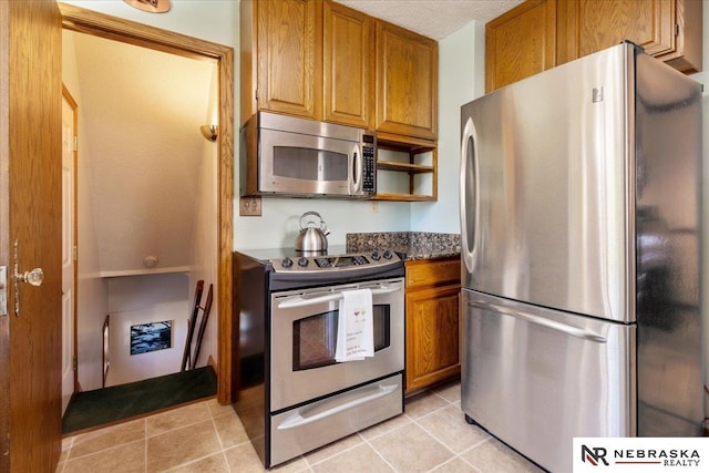 4542 Charles St, Omaha, NE 68132 - kitchen with stainless steel appliances, brown cabinets, light tile patterned flooring, and open shelves