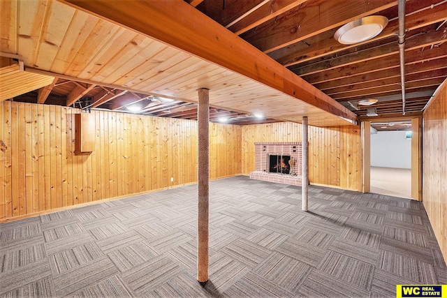 1341 Wilbur St, Blair, NE 68008 - finished below grade area with a brick fireplace, wooden walls, and carpet