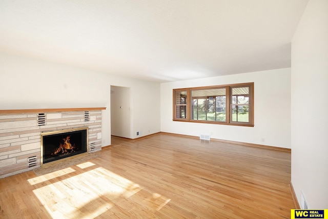 1341 Wilbur St, Blair, NE 68008 - unfurnished living room with a fireplace, light wood-style flooring, and baseboards
