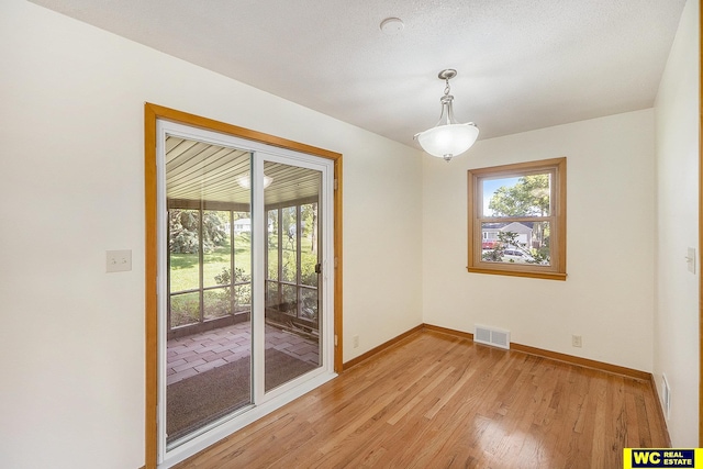 1341 Wilbur St, Blair, NE 68008 - unfurnished room with plenty of natural light, baseboards, and light wood-type flooring
