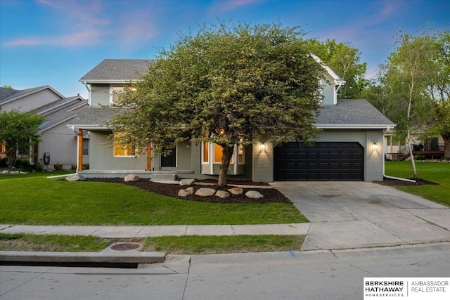 16324 Chicago St, Omaha, NE 68118 - view of property hidden behind natural elements with a garage, driveway, a front yard, and brick siding
