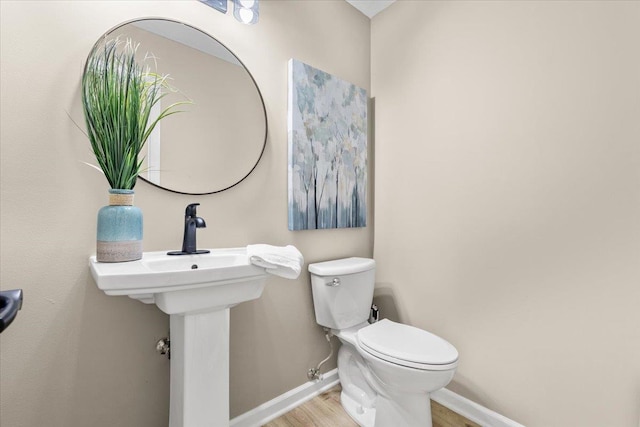 16324 Chicago St, Omaha, NE 68118 - half bath with baseboards, wood finished floors, toilet, and a sink